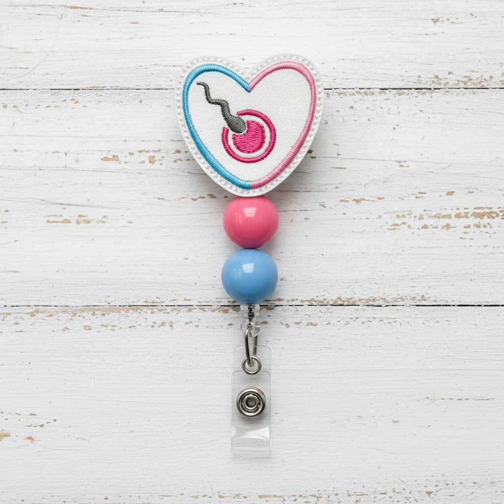 Heart-shaped badge holder with pink and blue beads on a white background