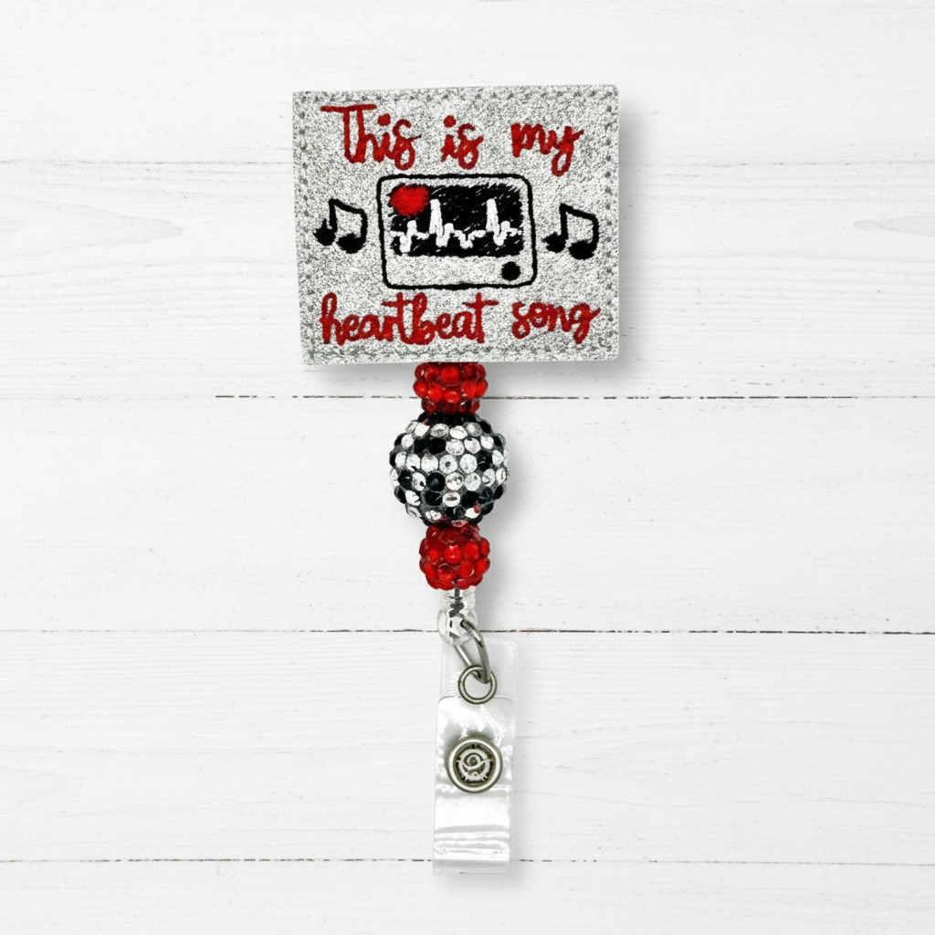 Retractable badge holder with decorative design and text on a white background