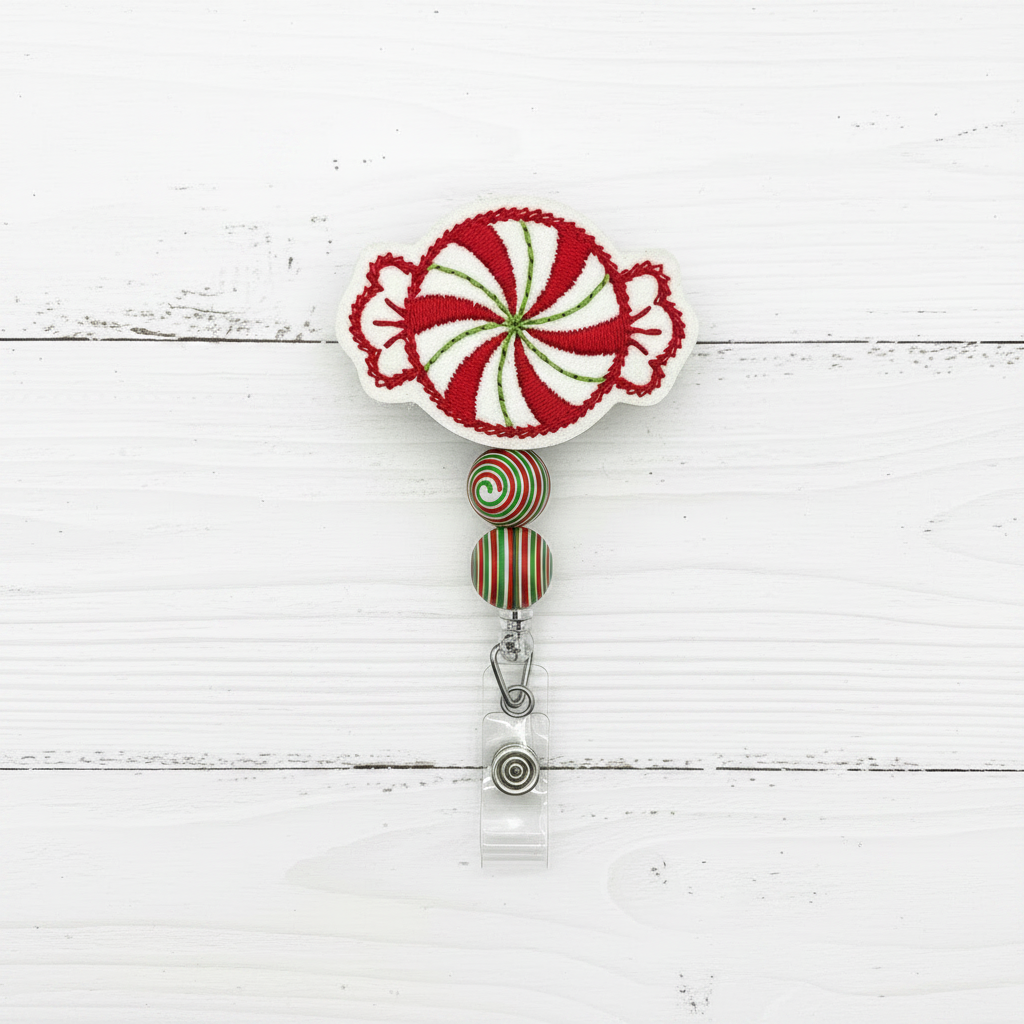 Decorative badge holder with candy cane design on a white wooden background with Christmas elements.