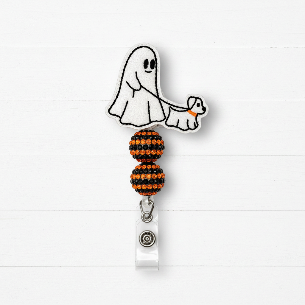 A Halloween-themed retractable badge reel featuring a white embroidered ghost and dog design with orange accents, attached to a clear plastic clip with a silver snap button, set against a white wood plank background.