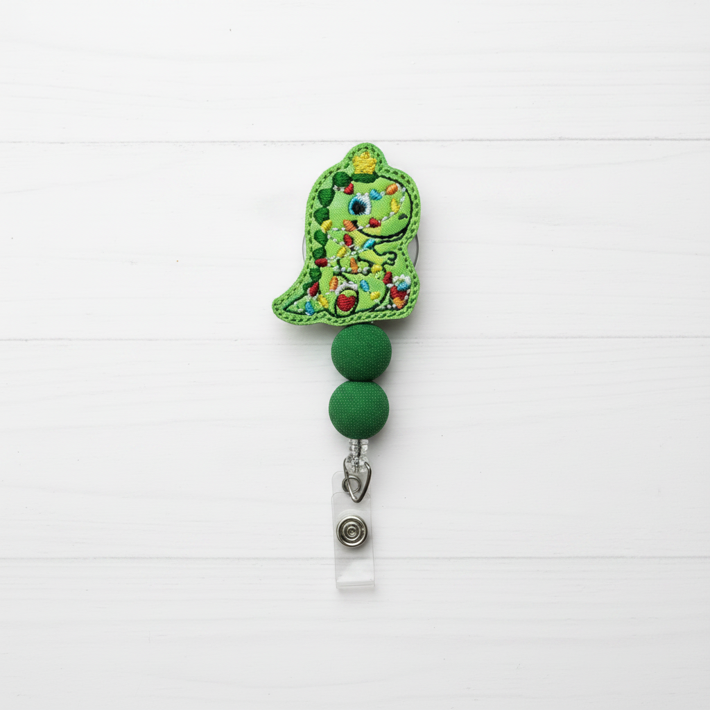 Decorative green badge holder with floral design on a white background