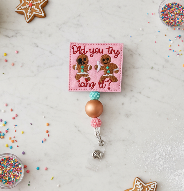 Baking setup with cookies, frosting, and a decorative badge on a light surface.