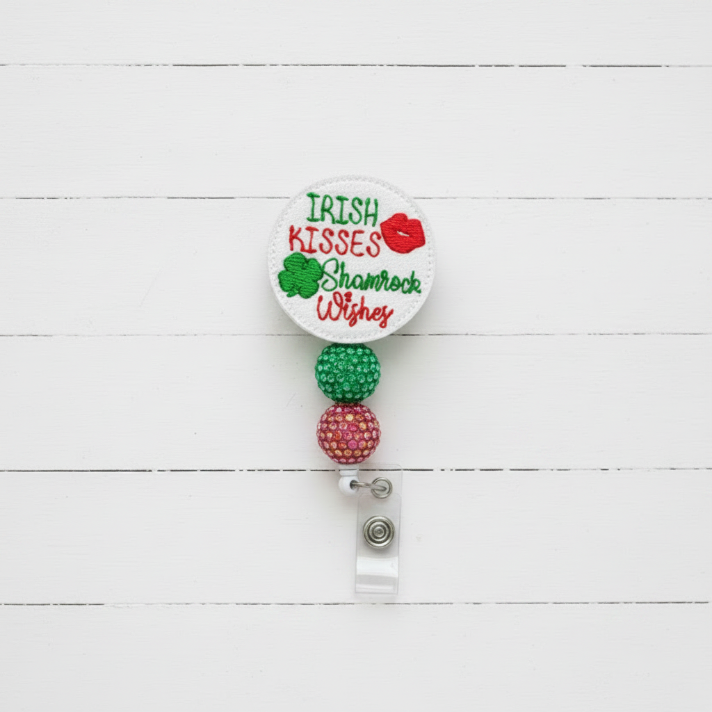 Retractable badge holder with 'Irish Kisses, Shamrock Wishes' text and colorful beads on a white background