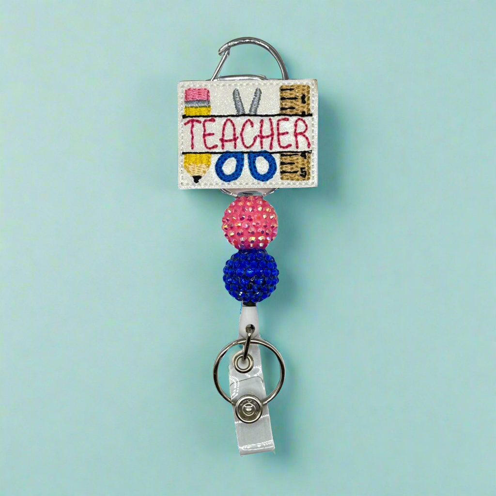 Teacher With Supplies Badge Reel