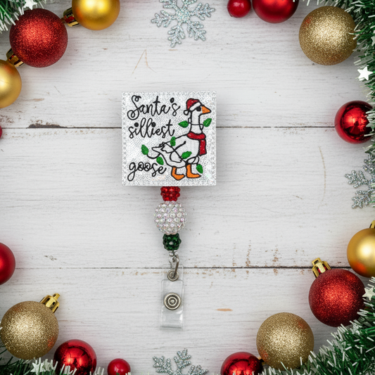 Christmas-themed badge holder with decorative elements on a wooden surface.