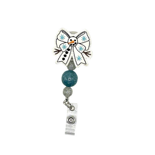 Snowman-themed badge holder with a bow and beads on a white background