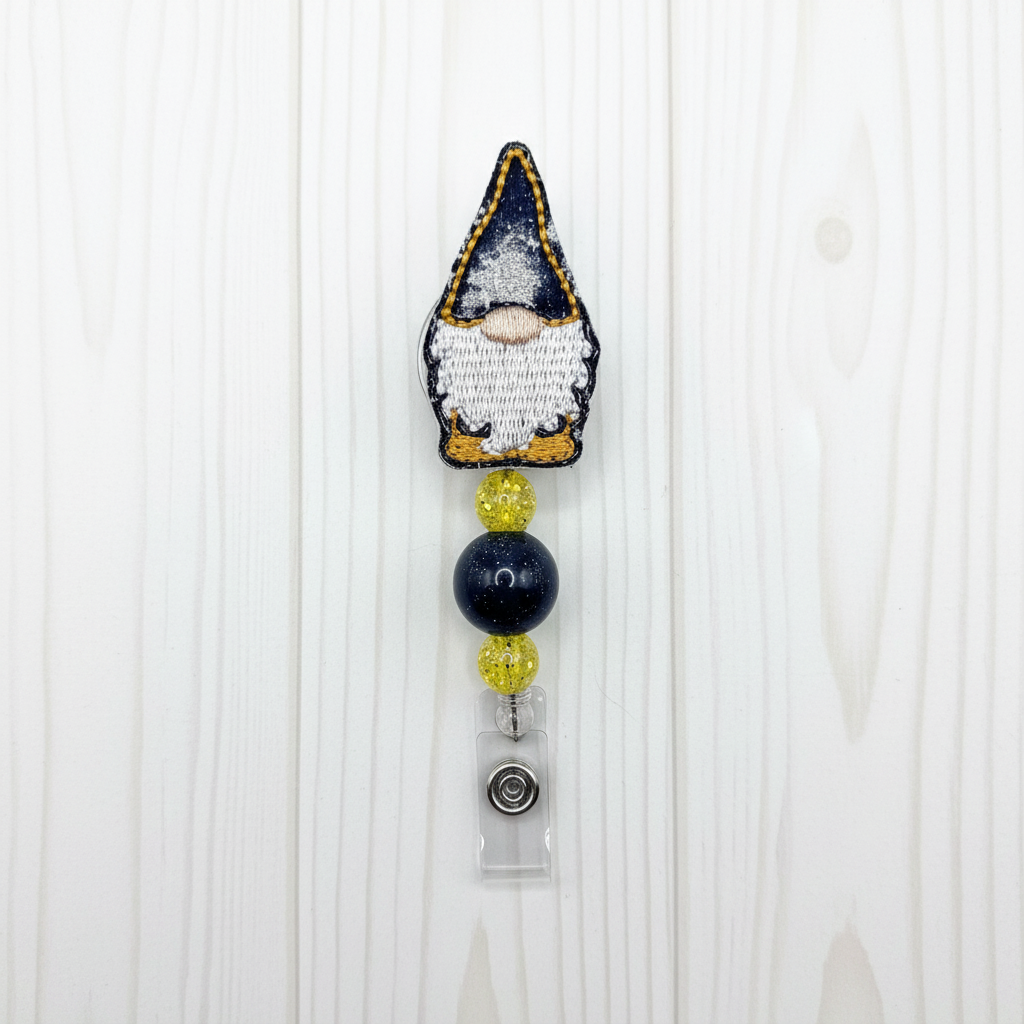 A black and gold gnome beaded badge reel with a retractable cord and rotating clip.