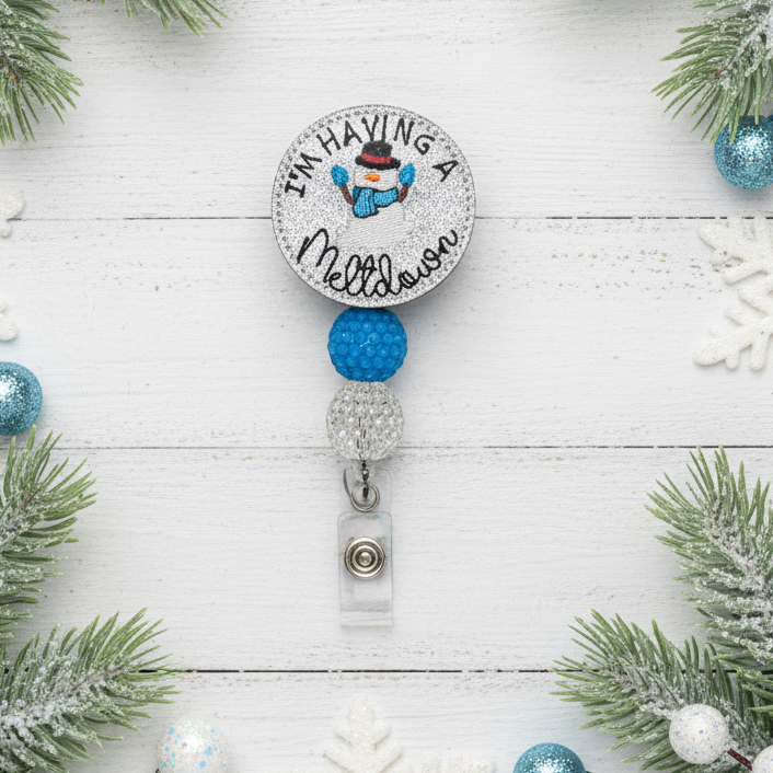 Retractable badge holder with snowman design and text on a white background