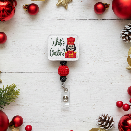 Christmas-themed badge holder with decorative ornaments on a white wooden background