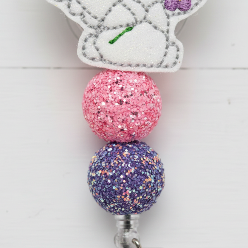 Lamb with Flower Badge Reel