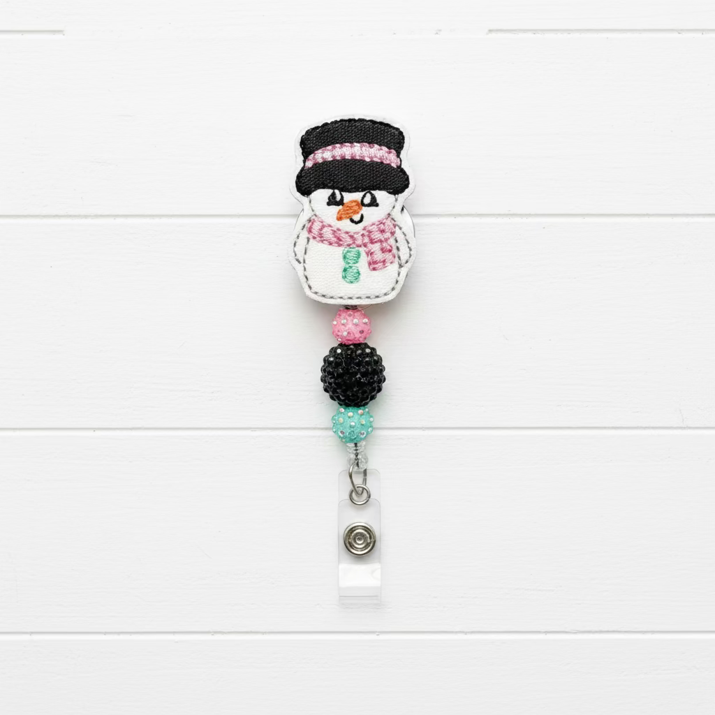 Snowman-themed badge holder with decorative beads on a white background with Christmas decorations.