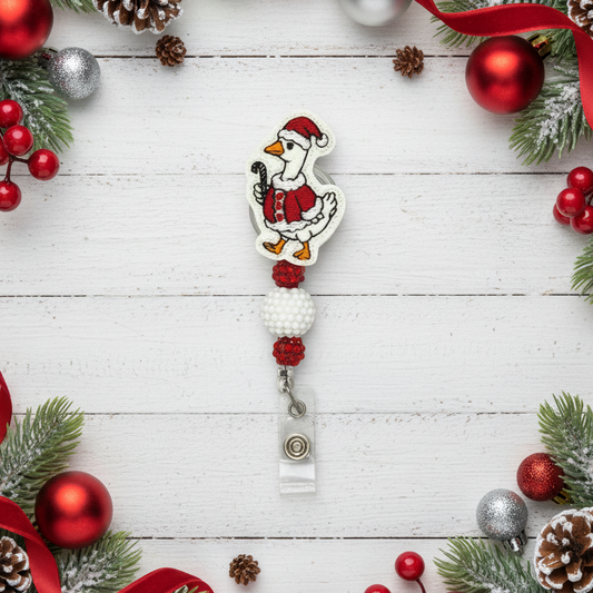 Christmas-themed badge holder with a festive design on a white wooden background with holiday decorations.