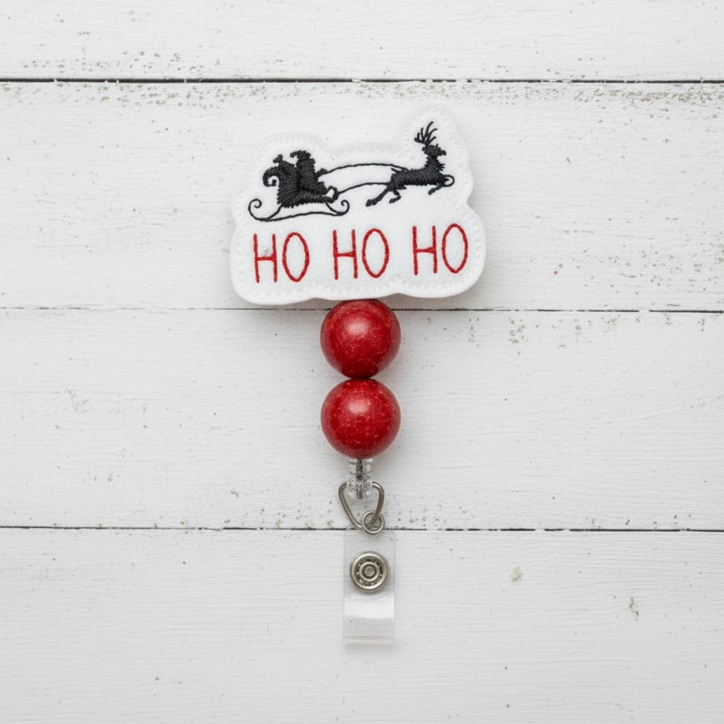 Christmas-themed badge holder with 'HO HO HO' text and reindeer design on a white wooden background with festive decorations.