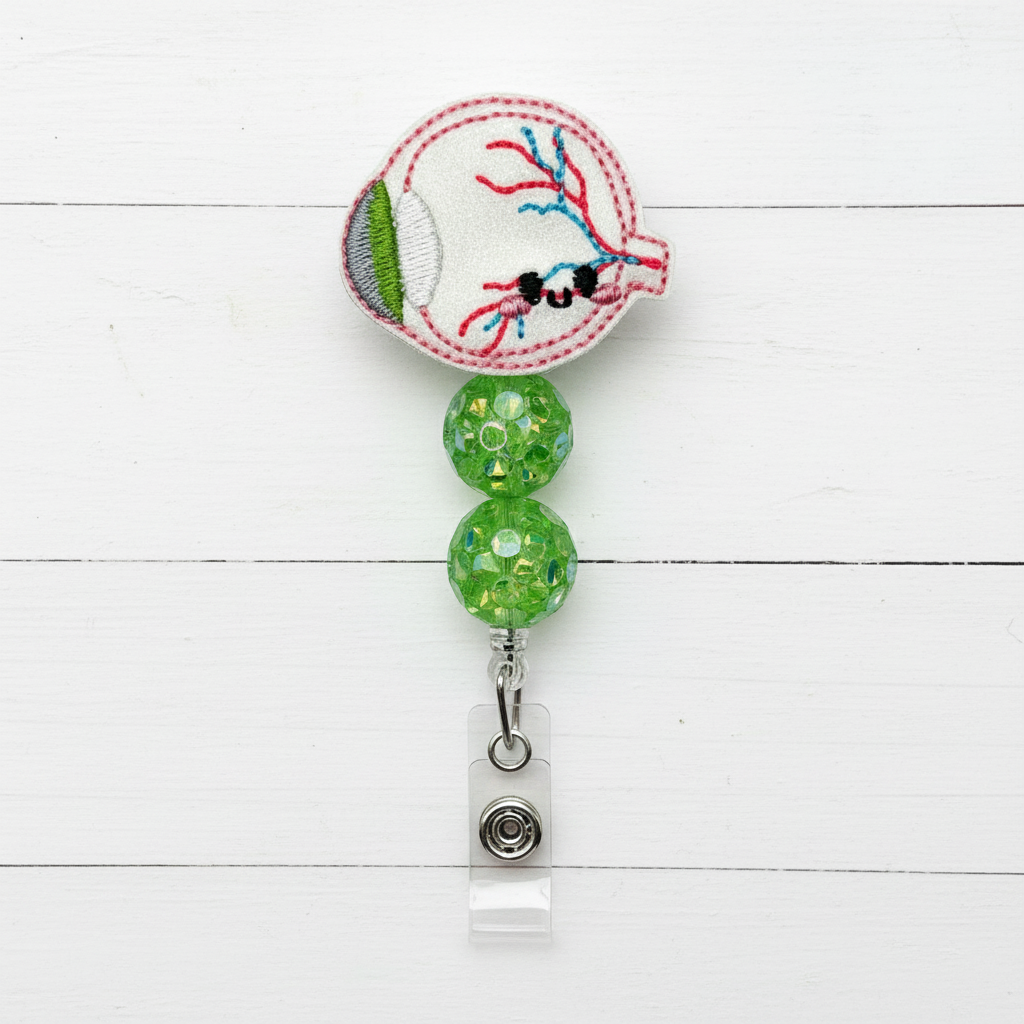 Badge holder with embroidered design and green beads on a white background