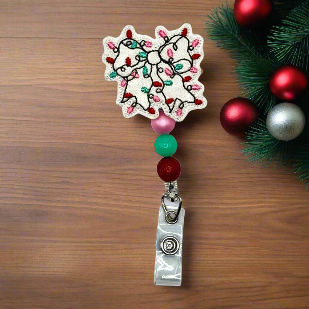 Christmas Light Bow Badge Reel