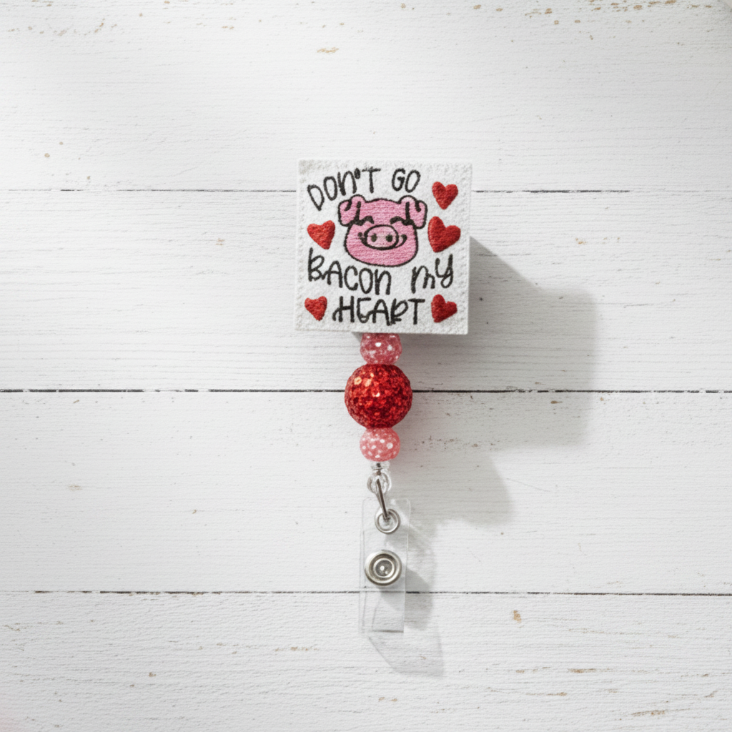 Badge holder with pig illustration and text on a white wooden background