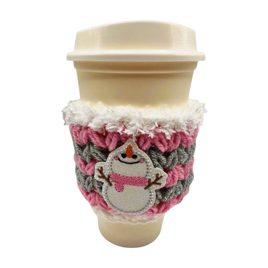 A coffee cozy sleeve with a snowman design, primarily in blue and gray tones, wrapped around a coffee cup.