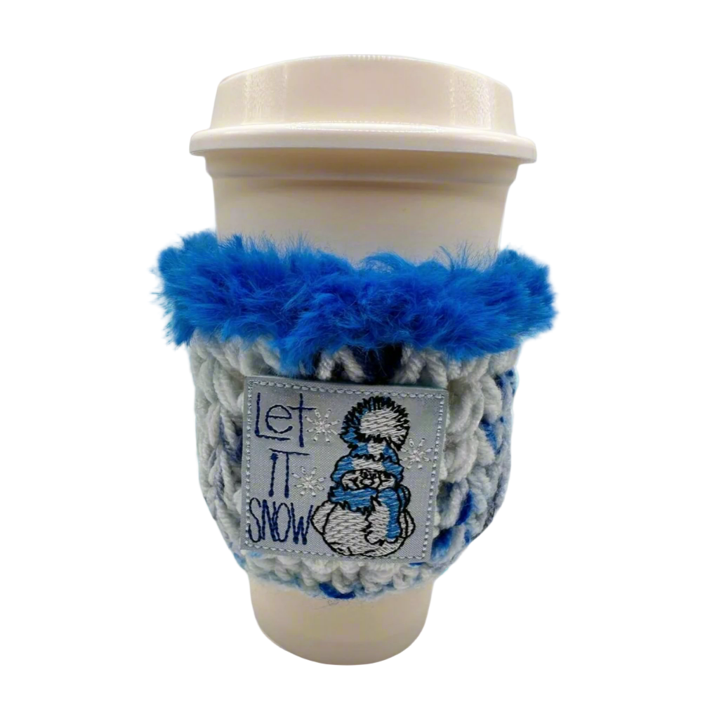 A coffee cozy with blue and white colors, featuring a snowman design and the text 'Let it snow'.