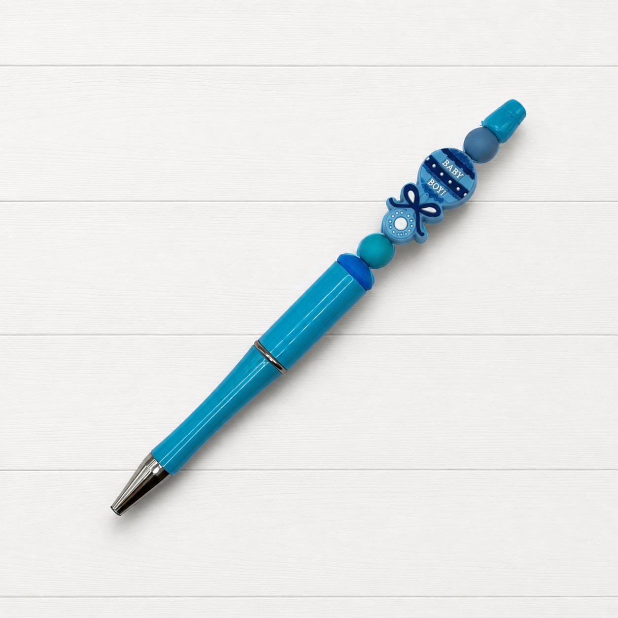 Baby Boy Beaded Pen on a clean white wood background