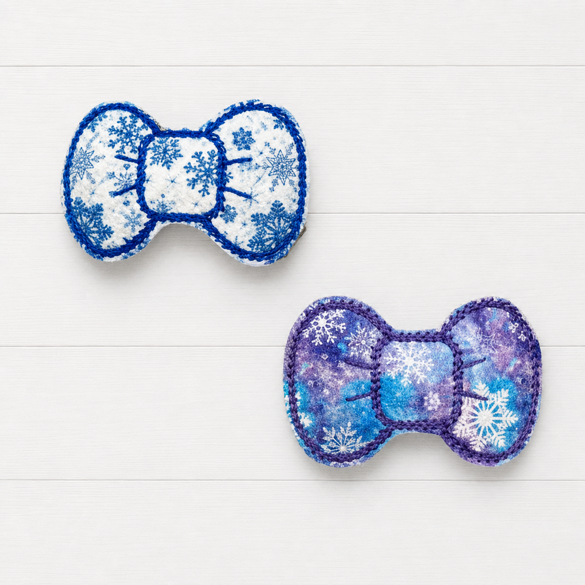 Blue and Purple Snowflake Bow Clips on a clean white wood background