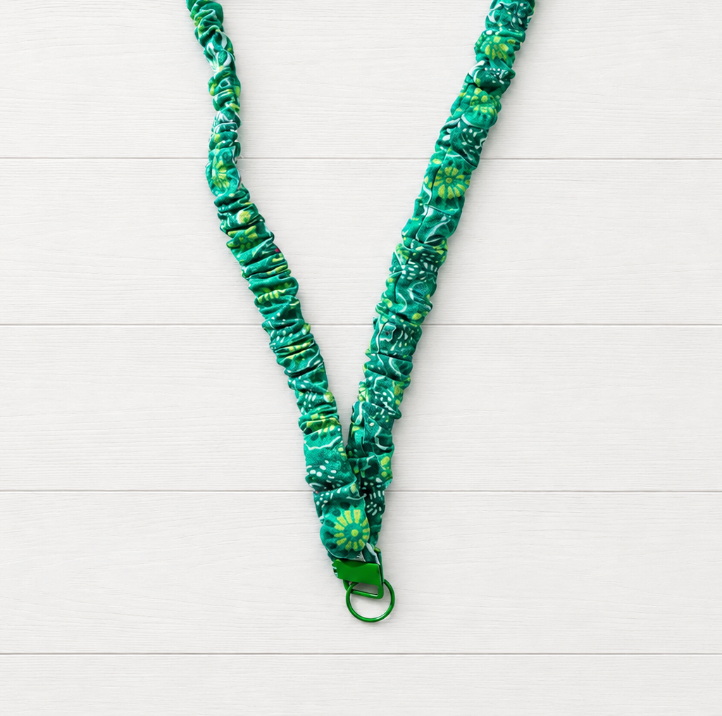 Green Flower Power Scrunchie Lanyard on a clean white wood background