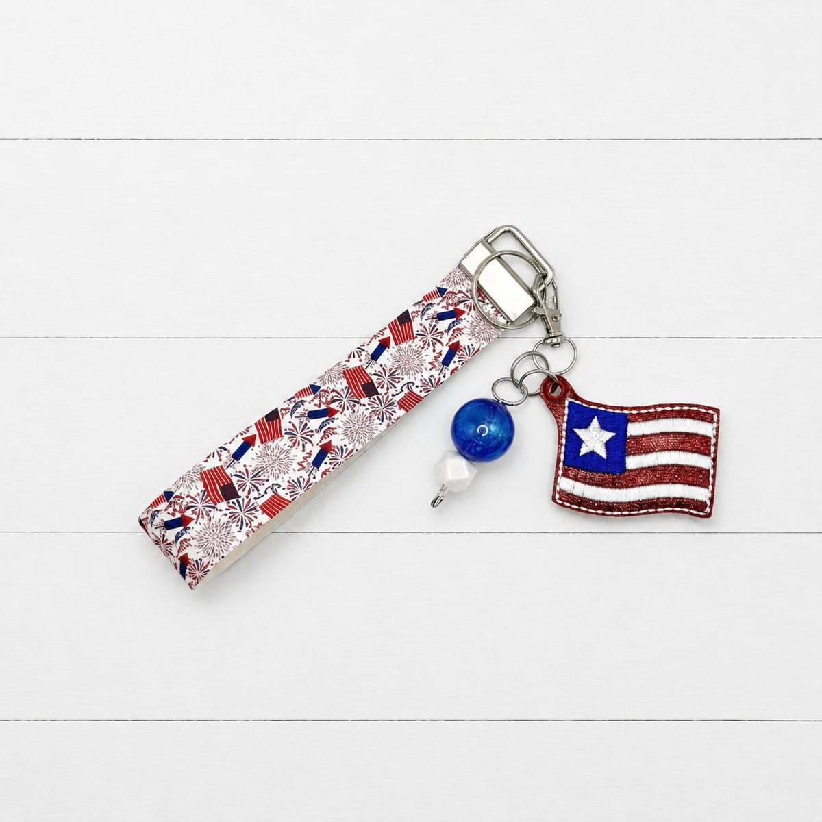 One Star Flag Keychain and Wristlet — clean white wood primary image