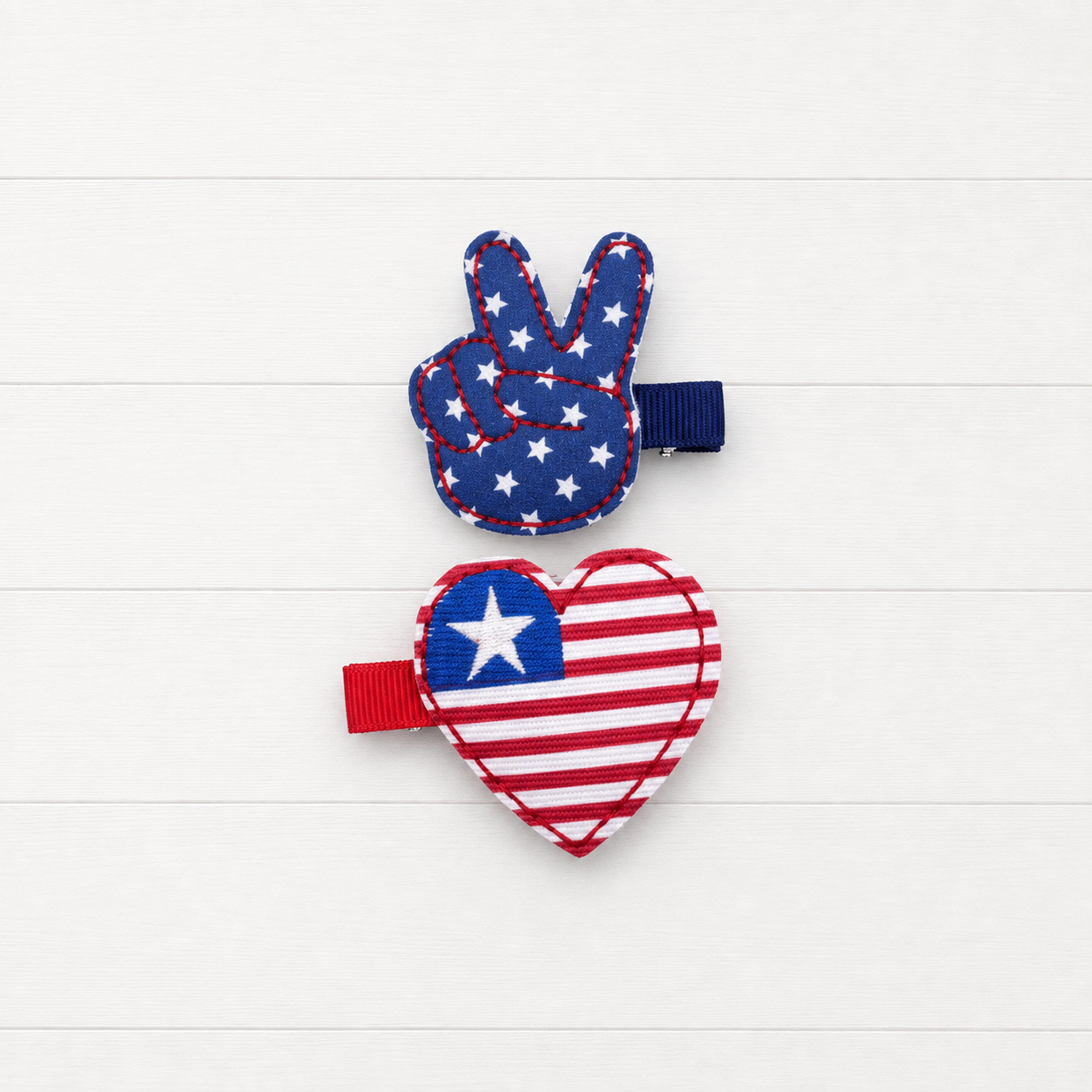 Stars and Stripes heart and peace Hair Bow Clips on a clean white wood background