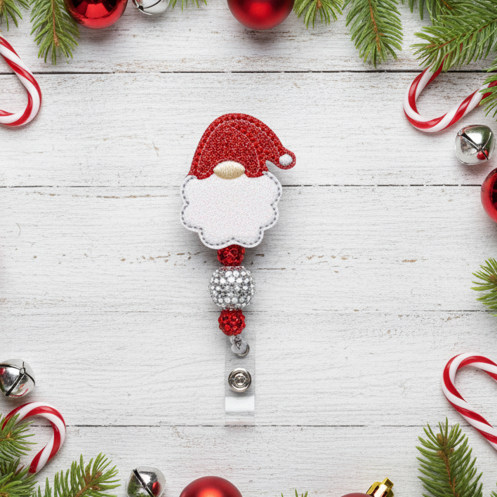 Decorative badge with Santa Claus design on a white wooden background with Christmas decorations.