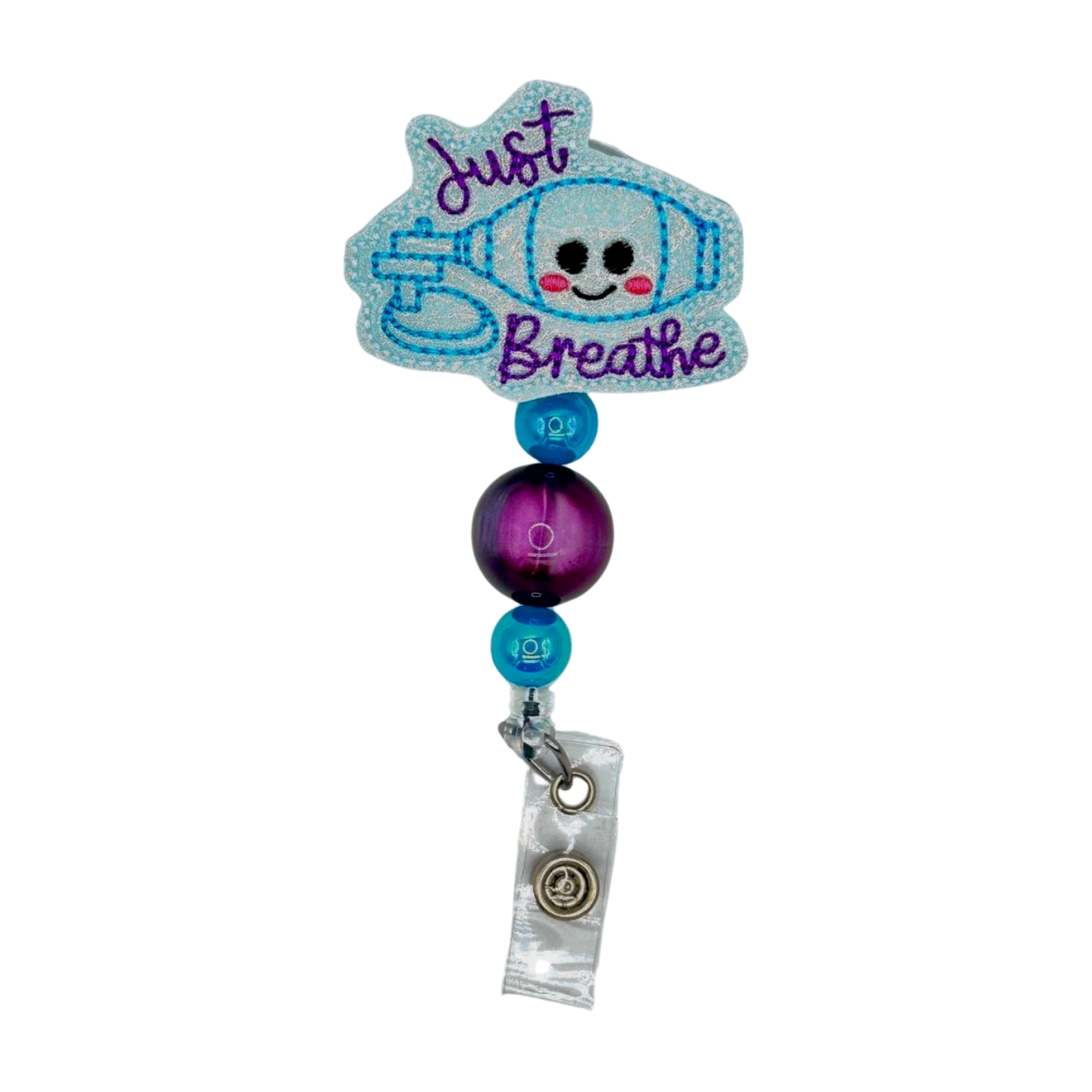 Retractable badge holder with cartoon character and 'Just Breathe' text on a white background