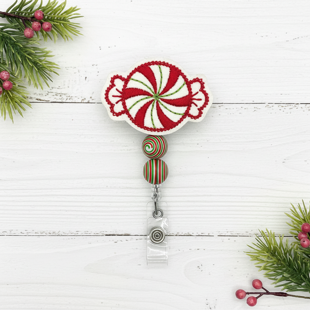 Decorative badge holder with candy cane design on a white wooden background with Christmas elements.
