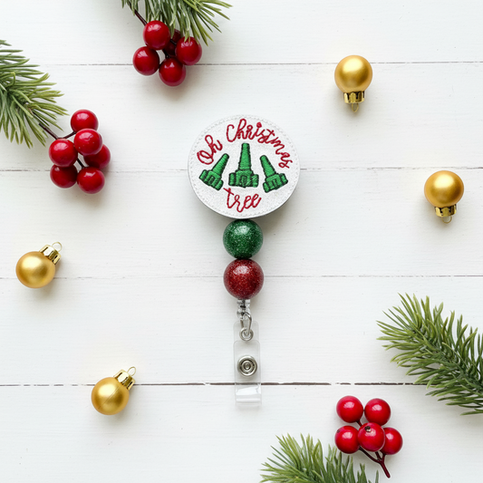 Christmas-themed badge holder with 'Oh Christmas Tree' text and green trees on a white background