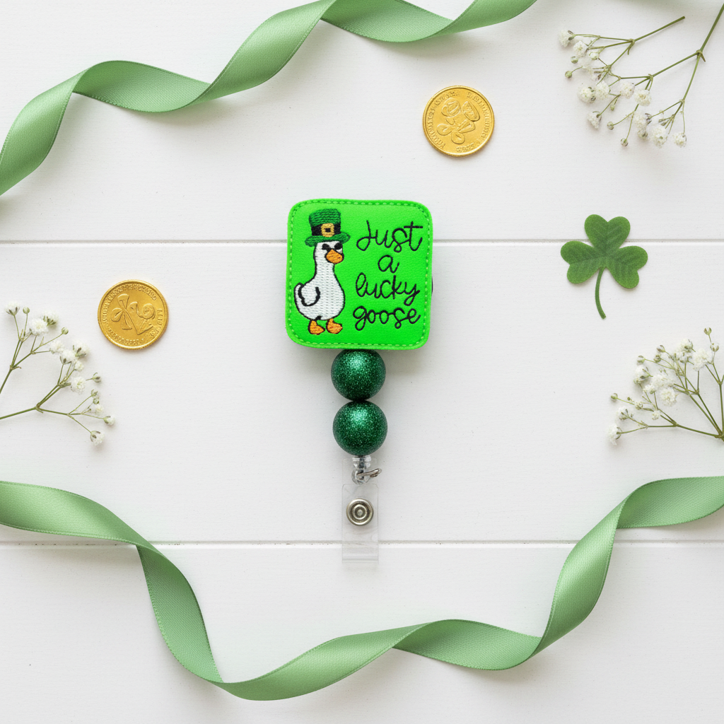 Retractable badge holder with a cartoon goose and text 'Just a lucky goose' on a green background.