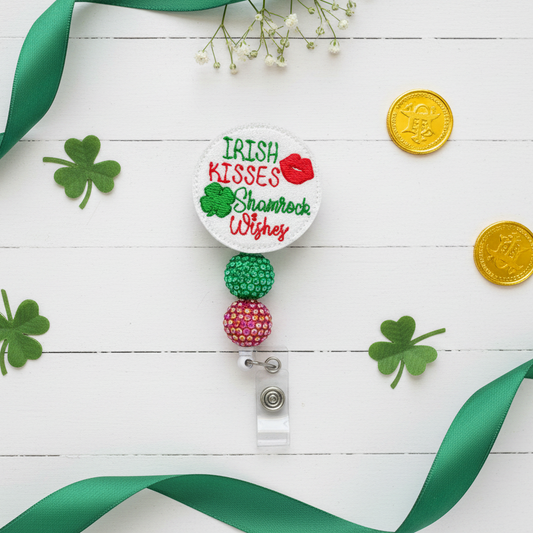 Retractable badge holder with 'Irish Kisses, Shamrock Wishes' text and colorful beads on a white background