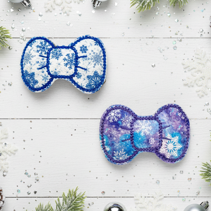 Two decorative bows with snowflake patterns on a festive background with Christmas decorations.