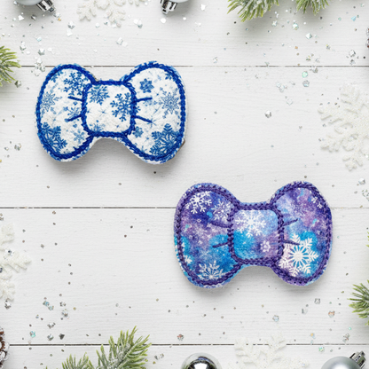 Two decorative bows with snowflake patterns on a festive background with Christmas decorations.