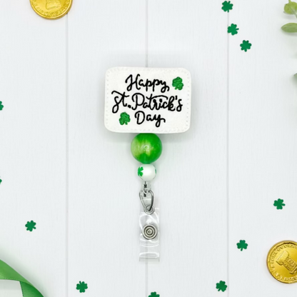 Retractable badge holder with 'Happy St. Patrick's Day' text and green accents on a white background