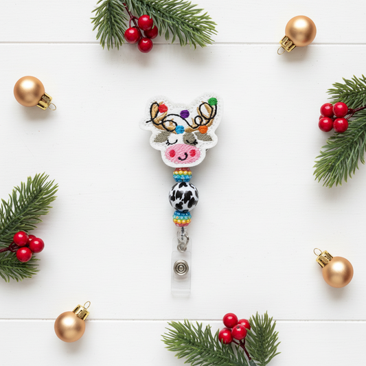 Colorful reindeer-themed keychain with beads on a white background