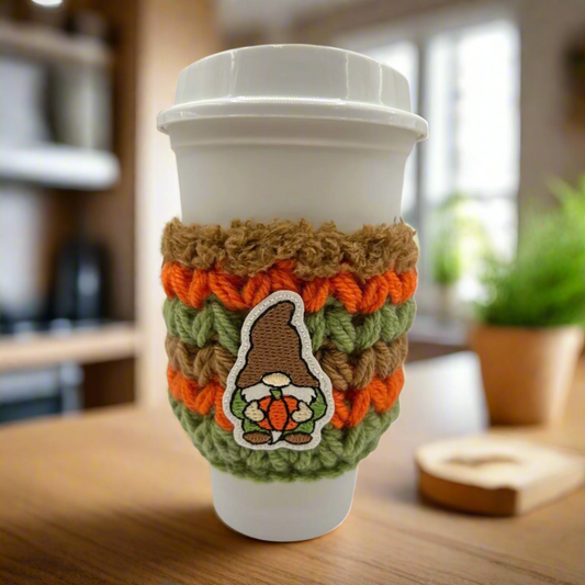 Gnome holding pumpkin coffee cozy