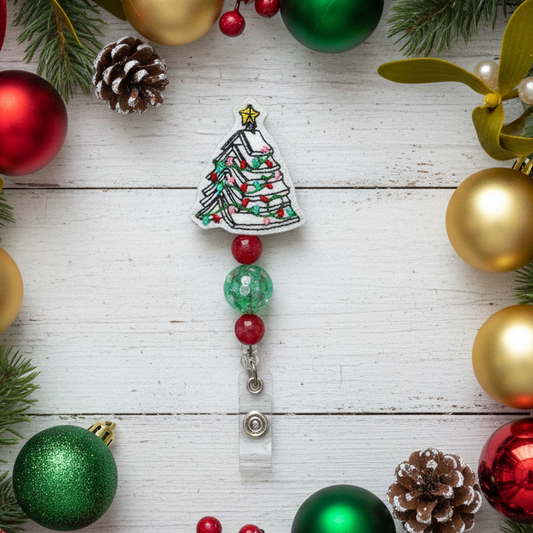 Decorative Christmas tree badge holder with beads on a wooden surface surrounded by festive ornaments.