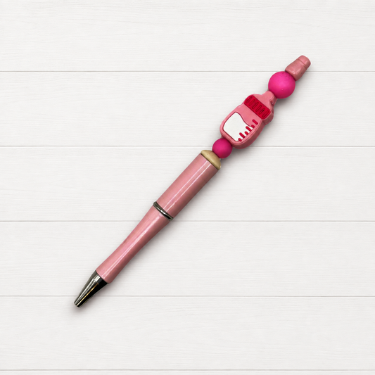 Baby Bottle Beaded Pen on a clean white wood background