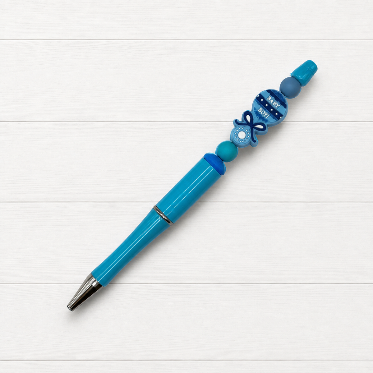 Baby Boy Beaded Pen on a clean white wood background