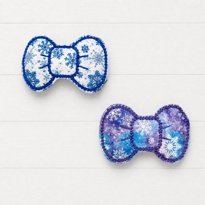 Blue and Purple Snowflake Bow Clips on a clean white wood background