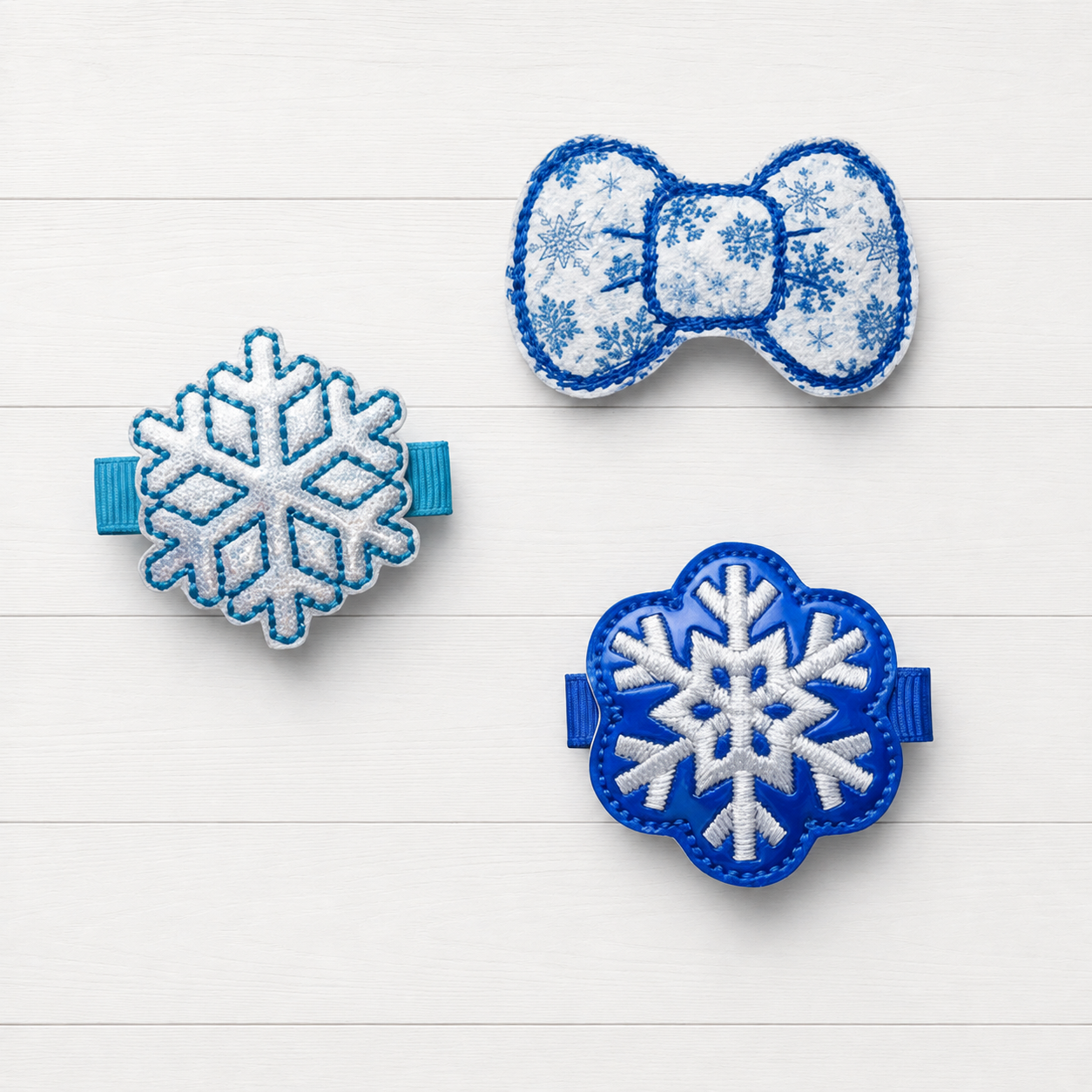 Blue Snowflake Hair Bow Clips on a clean white wood background