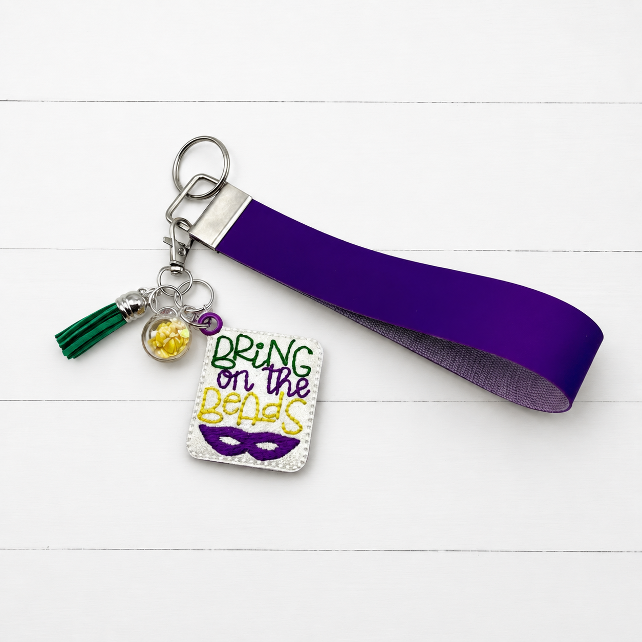 Bring on the Beads Mardi Gras Keychain and Wristlet on clean white painted wood background