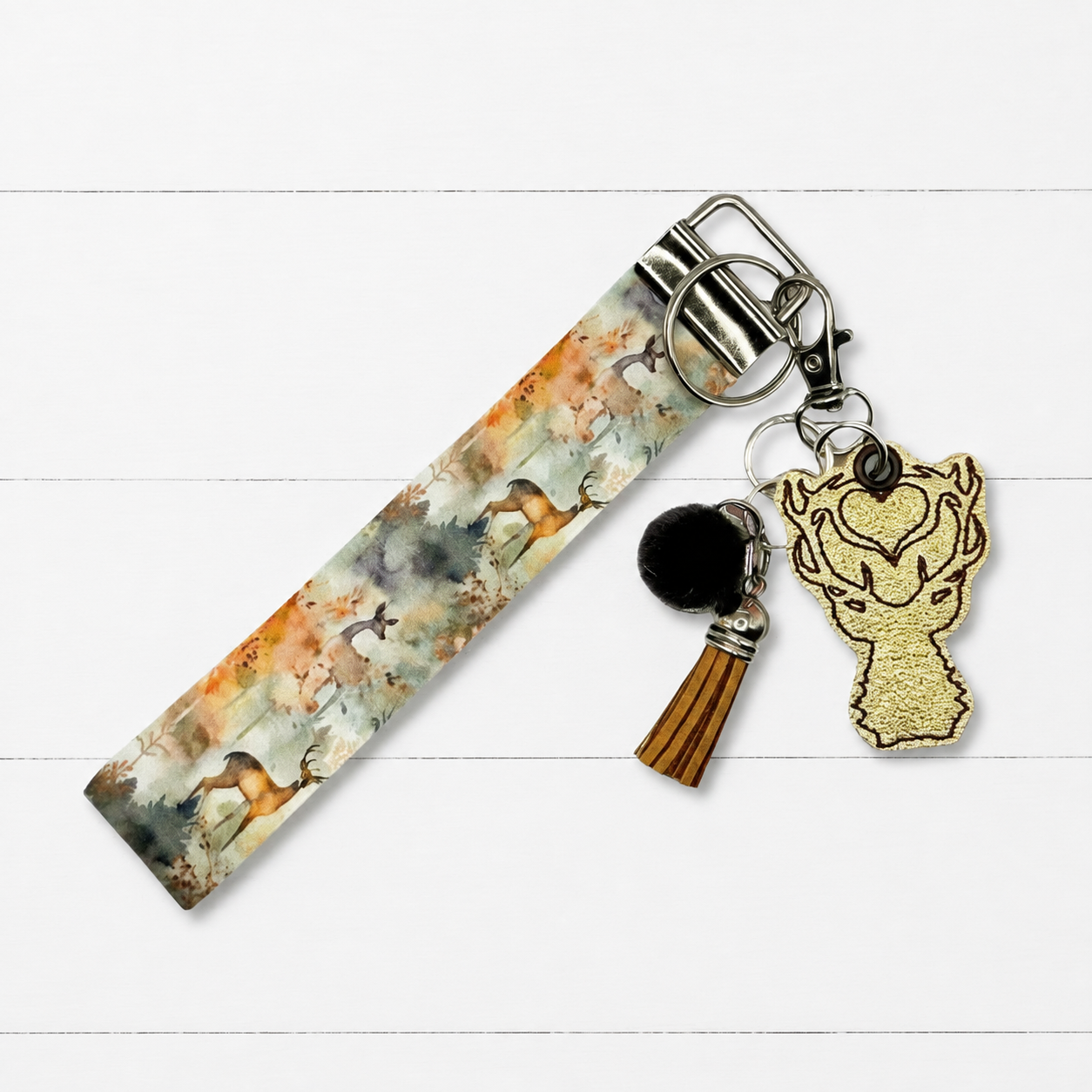 Buck Keychain and Wristlet on clean white painted wood background