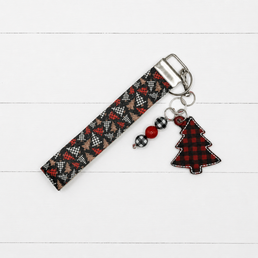 Buffalo Plaid Christmas Tree Keychain and Wristlet on clean white painted wood background