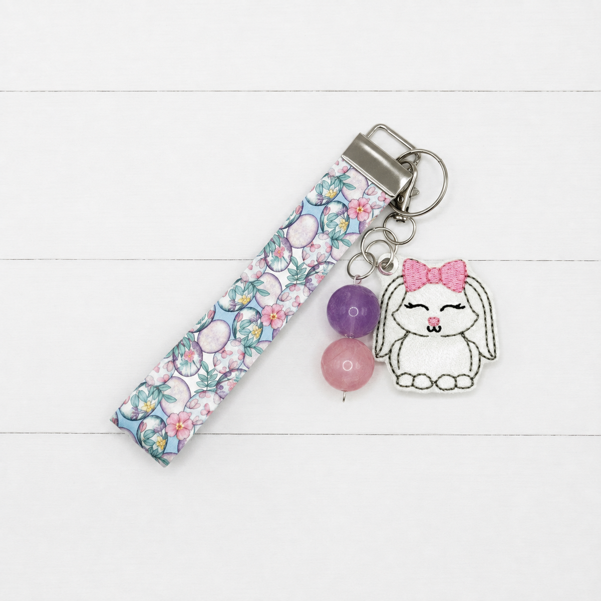 Bunny with Bow Keychain and Wristlet on clean white painted wood background