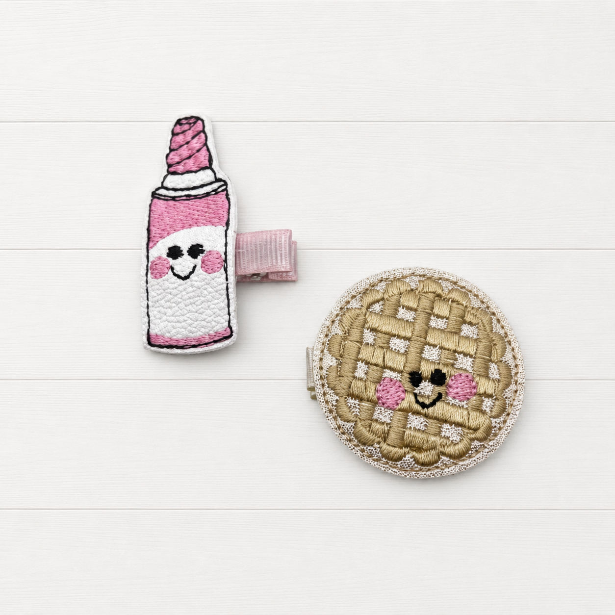 Pie and whip cream hair clip on a clean white wood background