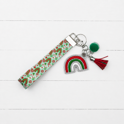 Candy cane Rainbow Keychain and Wristlet on clean white painted wood background