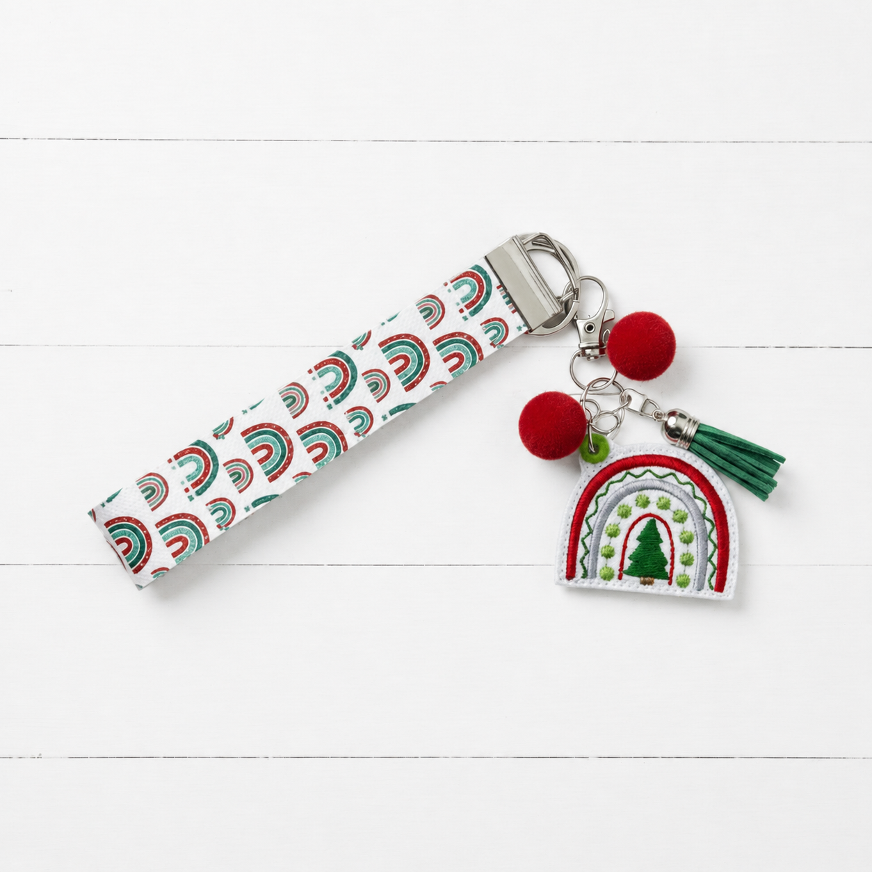 Christmas Tree Rainbow Keychain and Wristlet on clean white painted wood background